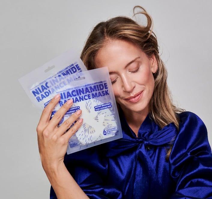 Model holding the Niacinamide Radiance Mask
